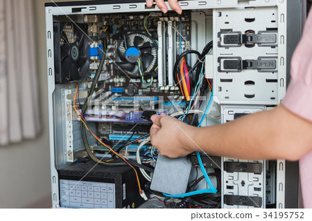 Young woman repairing computer Young woman repairing computer 34195752
