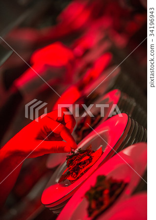 Male chef garnishing his dish, ready to serve 34196943