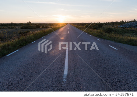 Straight country road in an open landscape Straight country road in an open landscape 34197671
