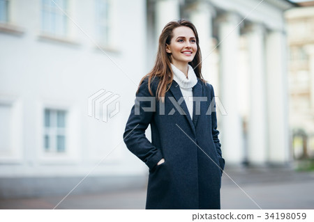 Laughing beautiful woman in city street Laughing beautiful woman in city street 34198059