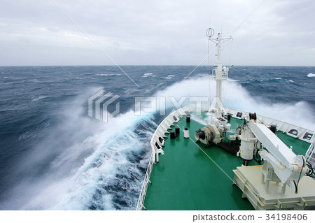 Ship's Bow diving into a big splashing wave 34198406