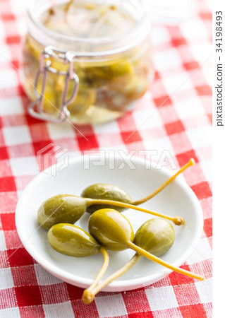 Pickled caper berries. 34198493