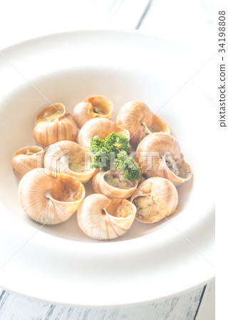 Portion of cooked snails 34198808