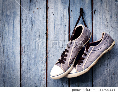 pair of old man's dirty blue sneakers 34200334