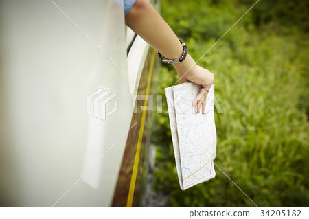 Someone is putting a map out of the train. Someone is putting a map out of the train. 34205182