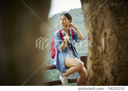 The girl is sitting and wiping sweat from her cheeks after a long trip 34205282