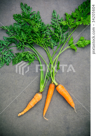 Fresh carrots bunch on wooden table. Fresh carrots bunch on wooden table. 34205604