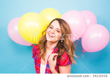 Young pretty woman with colored balloons Young pretty woman with colored balloons 34210338