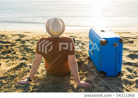 Man with suitcase on the beach. Summer travel and Man with suitcase on the beach. Summer travel and 34211068