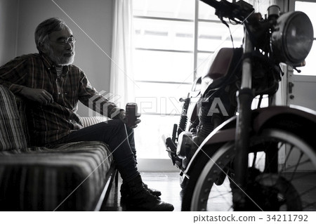 Senior man looking at a bike 34211792