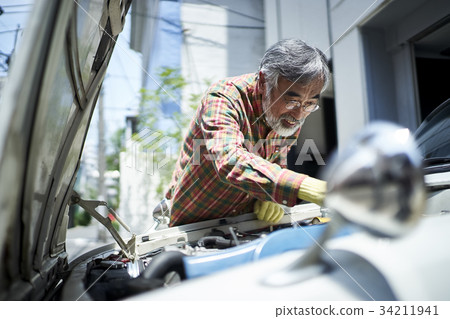 Senior man repairing a car Senior man repairing a car 34211941