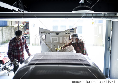 Senior man repairing a car 34211971