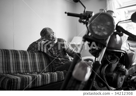 Senior man looking at a bike 34212308