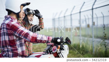 Senior men riding a motorcycle Senior men riding a motorcycle 34212319