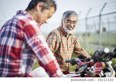 Senior men riding a motorcycle Senior men riding a motorcycle 34212320