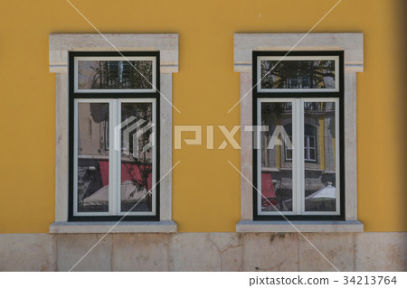 Two windows and a yellow facade Two windows and a yellow facade 34213764