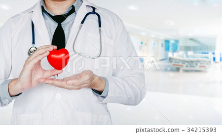 Doctor holding heart on background 34215393