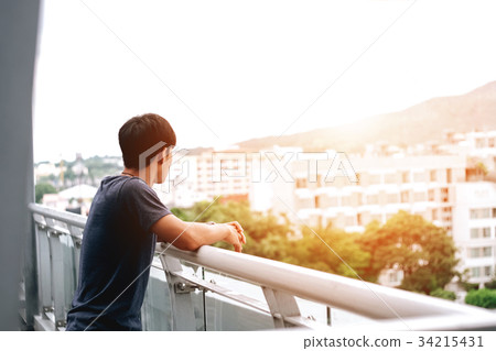 Lonely men are looking city view and sunset 34215431