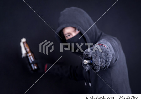 Protester or terrorist with Molotov cocktail 34215760