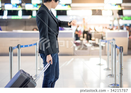 Young asian man waiting for the flight in airport Young asian man waiting for the flight in airport 34215787