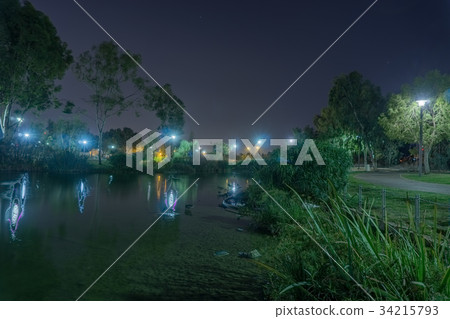 Trees reflecting in a Spreckles Lake with many 34215793