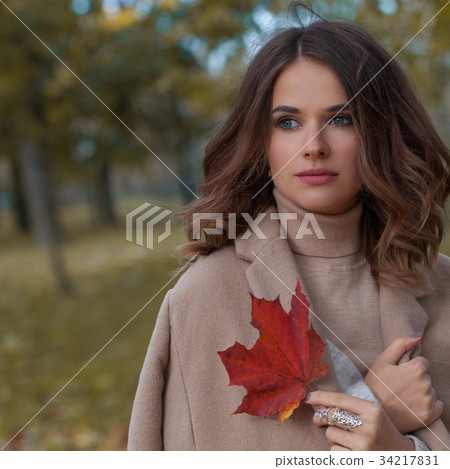 Nice Woman in Cold Autumn Day Outdoors 34217831