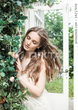 Beautiful Woman in Spring Rose Garden Outdoors 34217834