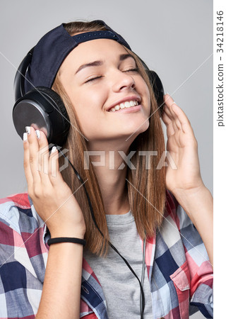 Teen girl listening enjoying music Teen girl listening enjoying music 34218146