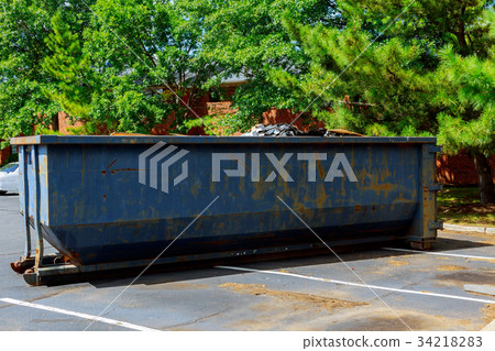 Dumpsters being full with garbage in a city. Dumpsters being full with garbage in a city. 34218283