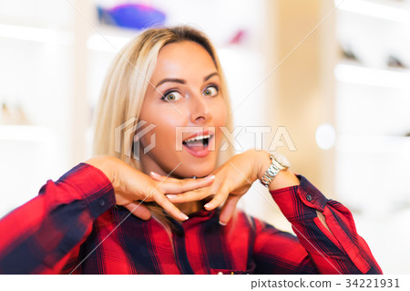 Portrait of young dreaming woman in fashion store 34221931