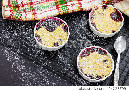 Two homemade mix berry oats crumble white ramekin Two homemade mix berry oats crumble white ramekin 34222799