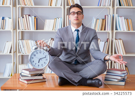 Businessman student in lotus position with an 34225573