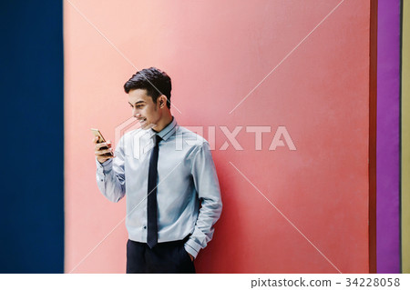 Happy Businessman use a Smart phone Happy Businessman use a Smart phone 34228058
