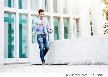 Happy Business working on tablet  34228059
