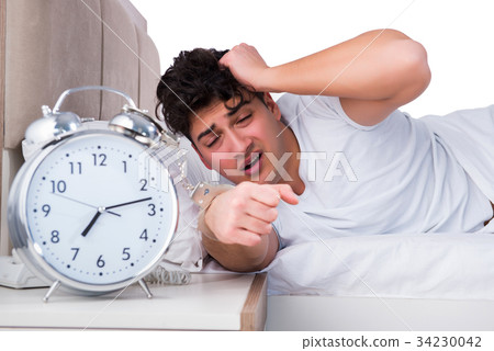 Man in bed suffering from insomnia 34230042