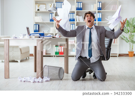 Angry businessman shocked working in the office Angry businessman shocked working in the office 34233300
