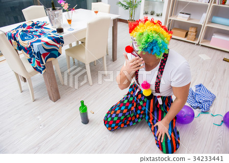 Drunk clown celebrating having a party at home 34233441