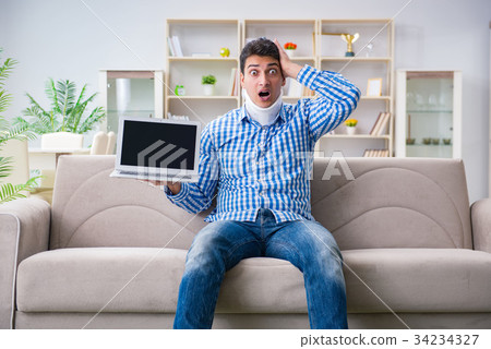 Man freelancer in a cervical collar neck brace Man freelancer in a cervical collar neck brace 34234327