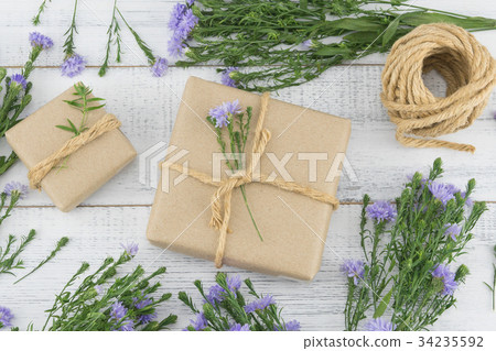 Brown gift boxes and rope with purple flowers 34235592