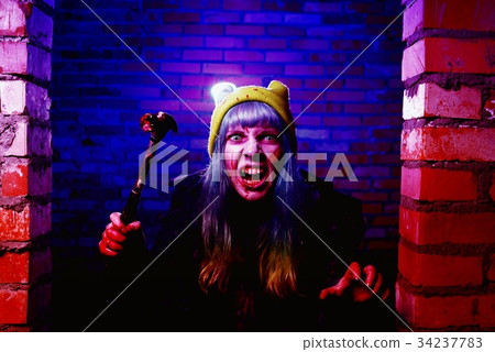 Portrait of funny zombie girl in halloween time with hammer 34237783