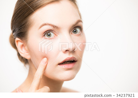 Caucasian woman checking skin Caucasian woman checking skin 34237921