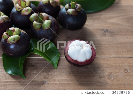 Fresh Mangosteen fruits on wood table top Fresh Mangosteen fruits on wood table top 34239756
