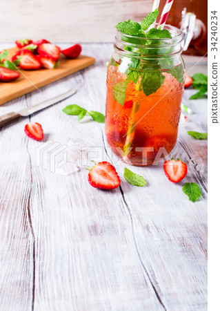 Glass jar with homemade strawberry compote Glass jar with homemade strawberry compote 34240234