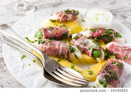 Rolls of mozzarella, basil and Parma ham Rolls of mozzarella, basil and Parma ham 34240883