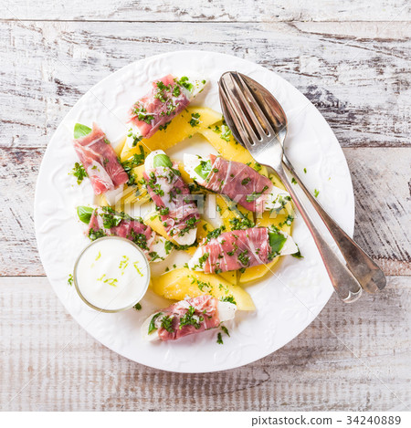 Rolls of mozzarella, basil and Parma ham 34240889