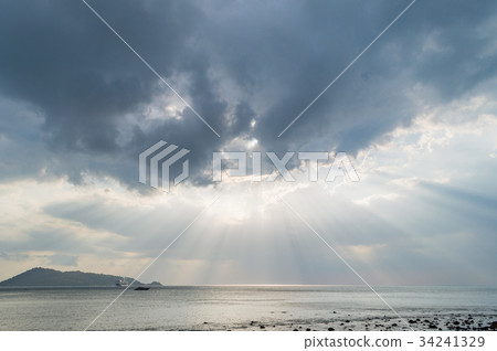Rays of light shining through dark clouds Rays of light shining through dark clouds 34241329