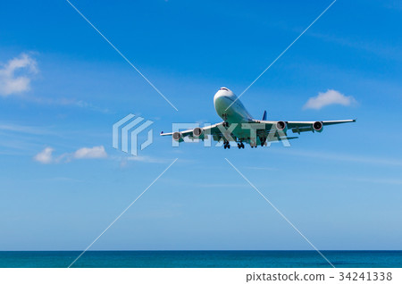 Airplane landing above beautiful beach Airplane landing above beautiful beach 34241338