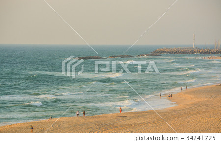 People walking on the beach of the Mediterranean 34241725