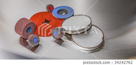 discs abrasive flap wheels on metallic background. 34242762