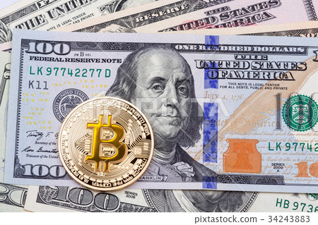 Golden yellow bitcoin on hundred banknotes Golden yellow bitcoin on hundred banknotes 34243883